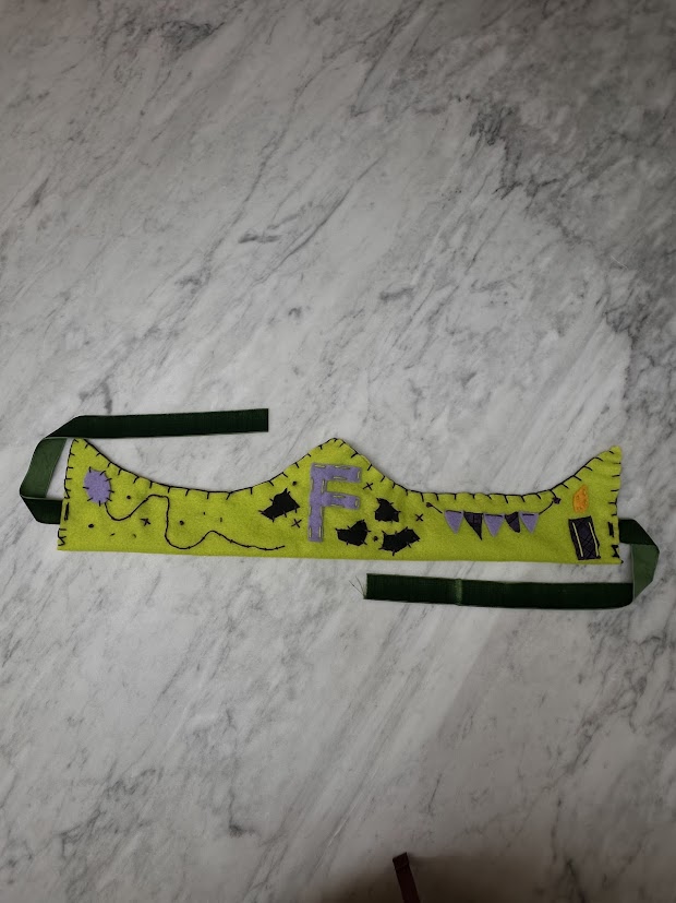 Lime green felt crown laid flat with bat embroidery