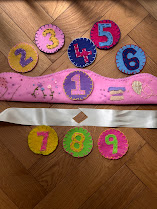 Pink felt crown with velcro number discs laid out showing the full number pack